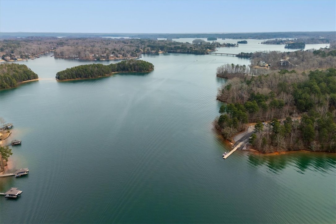 38 Angus Run Seneca, SC 29672 - Photo 44 of 46 This serene aerial view captures the vastness of the lake, surrounded by lush woodlands and scattered homes.