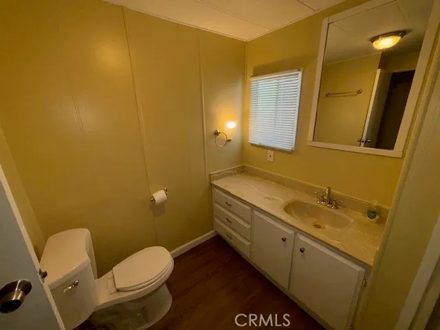 a bathroom with a granite countertop toilet and a sink