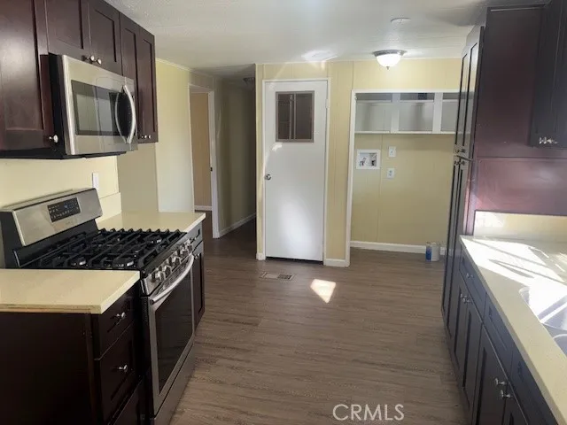 a kitchen with stainless steel appliances granite countertop a refrigerator and a stove top oven