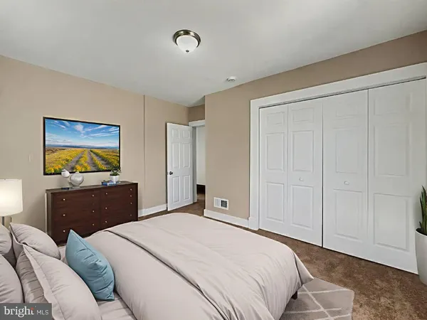 a bedroom with a bed and a cabinet