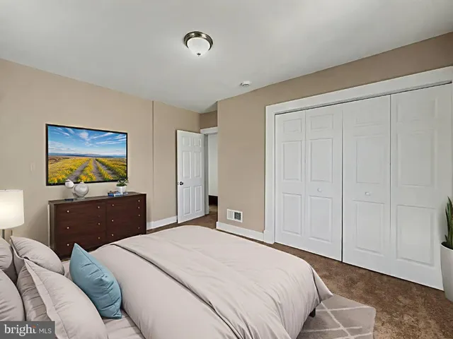 a bedroom with a bed and a cabinet