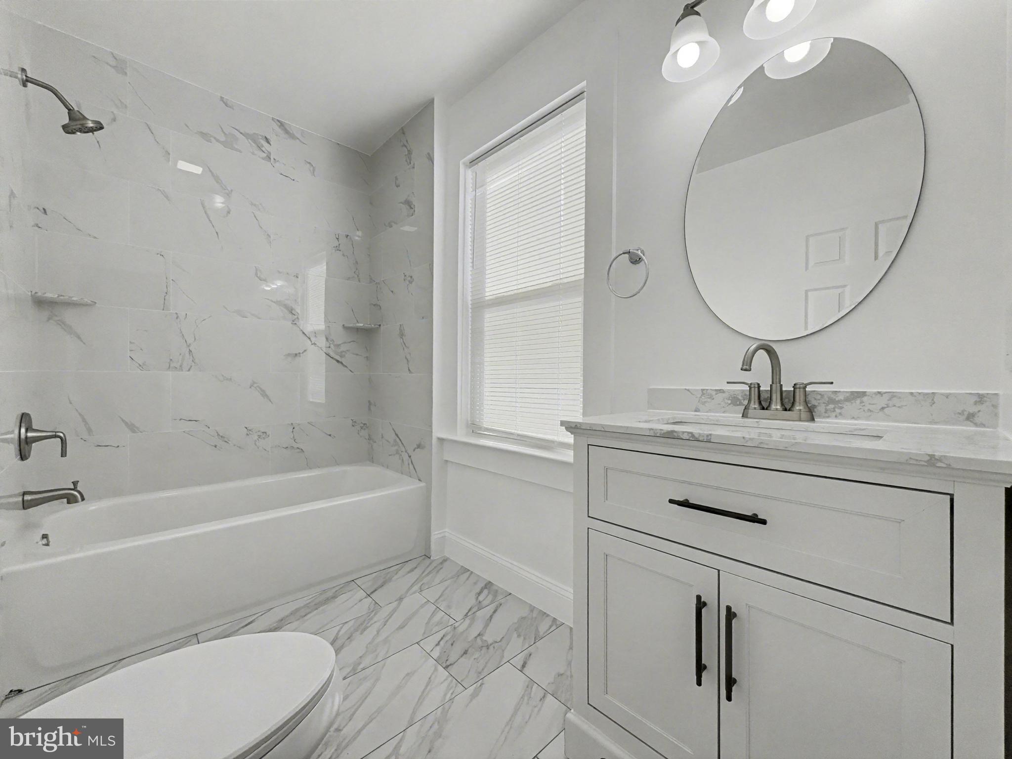 5505 Tramore Road Baltimore, MD 21214 - Photo 13 of 28 a bathroom with a sink a toilet and a mirror