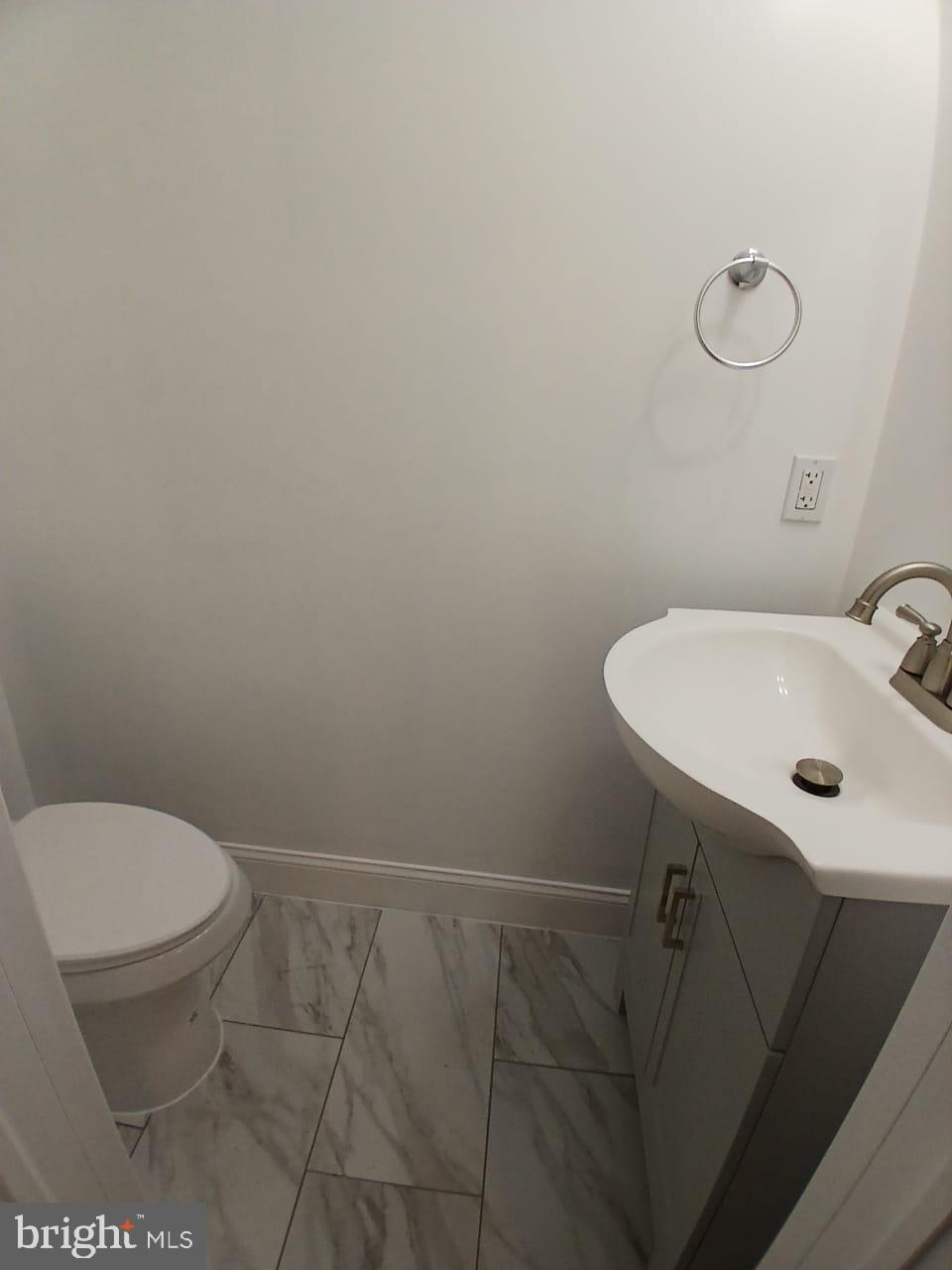 5505 Tramore Road Baltimore, MD 21214 - Photo 25 of 28 a bathroom with a sink a toilet and a mirror