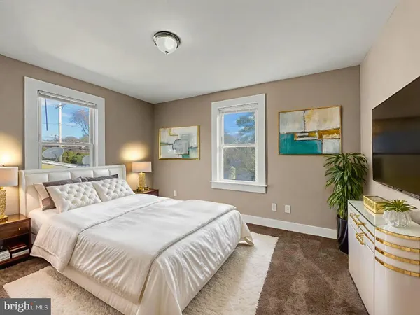 a bedroom with a bed and a flat screen television