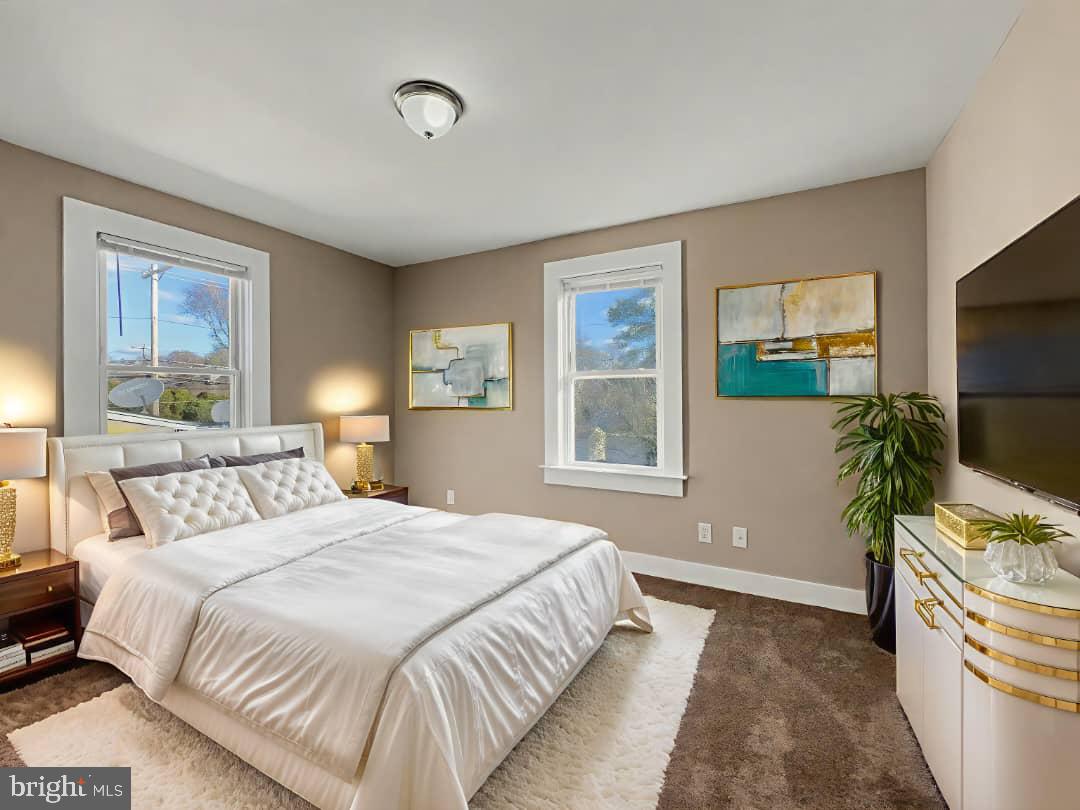 5505 Tramore Road Baltimore, MD 21214 - Photo 8 of 28 a bedroom with a bed and a flat screen television