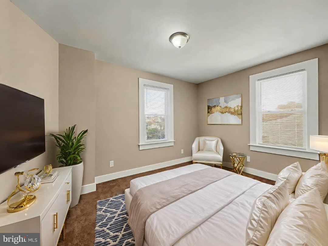 5505 Tramore Road Baltimore, MD 21214 - Photo 10 of 28 a bedroom with a large bed and a flat tv screen