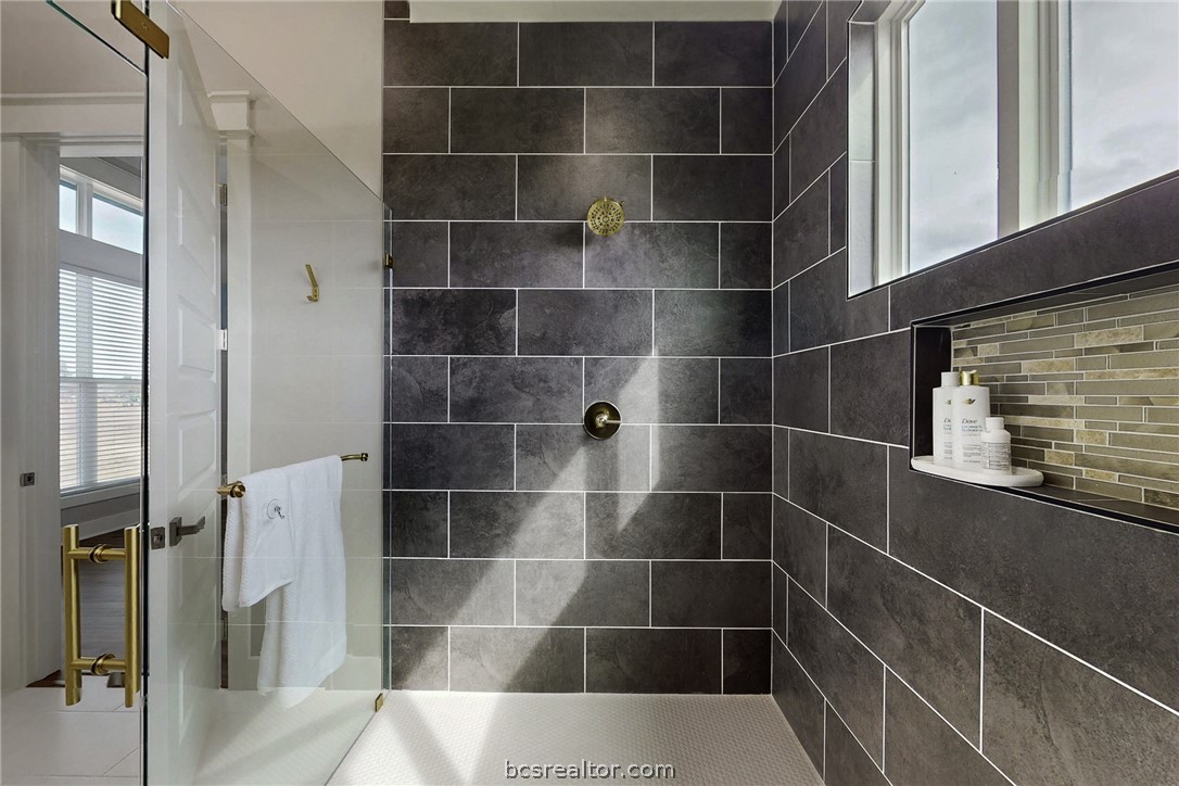 13504 Hudson Farms Road Hearne, TX 77859 - Photo 27 of 48 Totally separate shower at one end of the enclosure and the tub at the deep soaker tub at the other end. With Floor to ceiling tile. Just look at all that natural light! Why put up curtains when the property is totally private?
