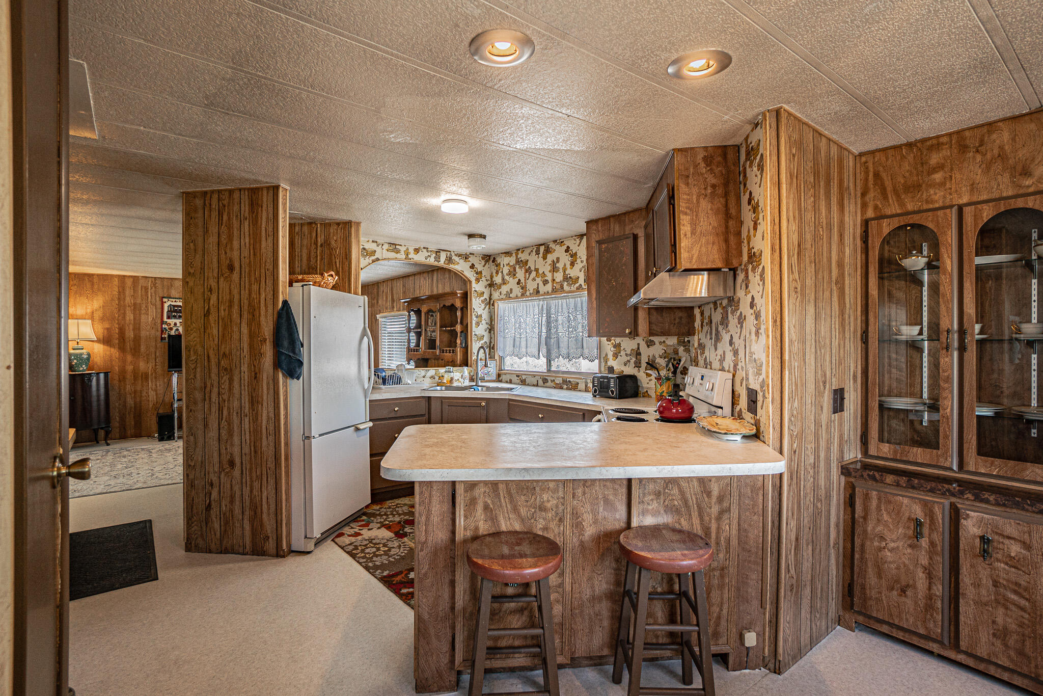 421 Stevens Road, Unit 26 Eagle Point, OR 97524 - Photo 7 of 23 a kitchen with refrigerator a sink and cabinets