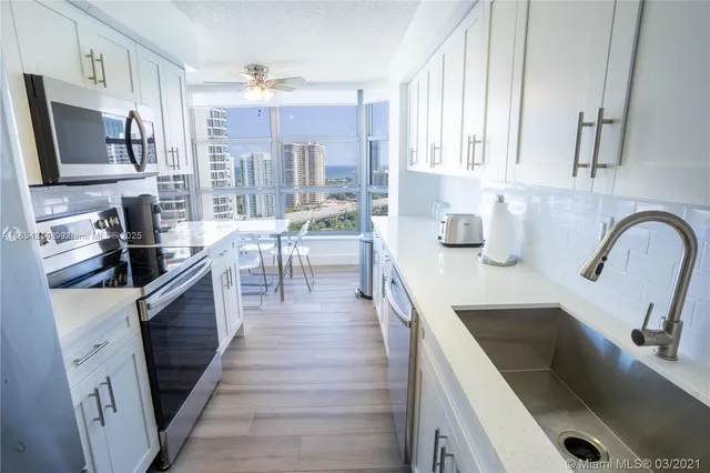 a bedroom with two beds and a chandelier