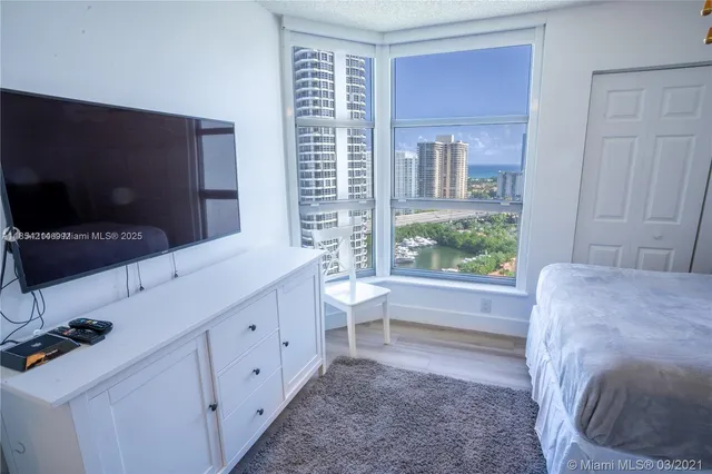 a bedroom with two beds and painting on the wall