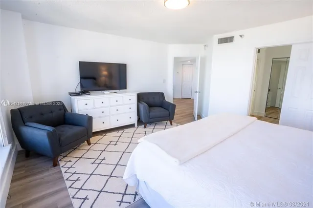 a spacious bathroom with a double vanity sink a mirror and a shower