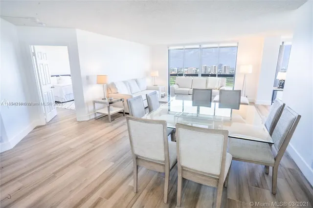 a dining room with furniture and wooden floor