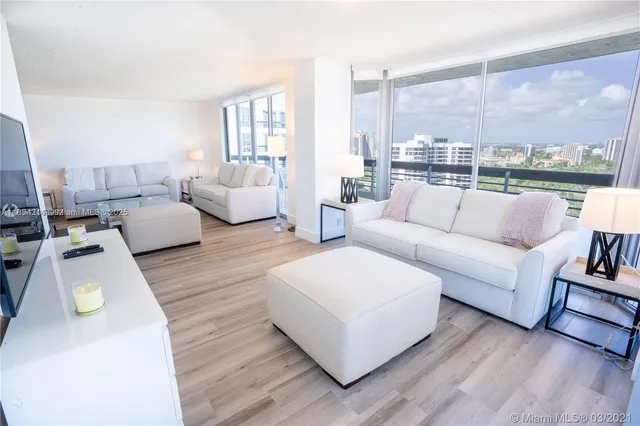 a living room with furniture and a large window