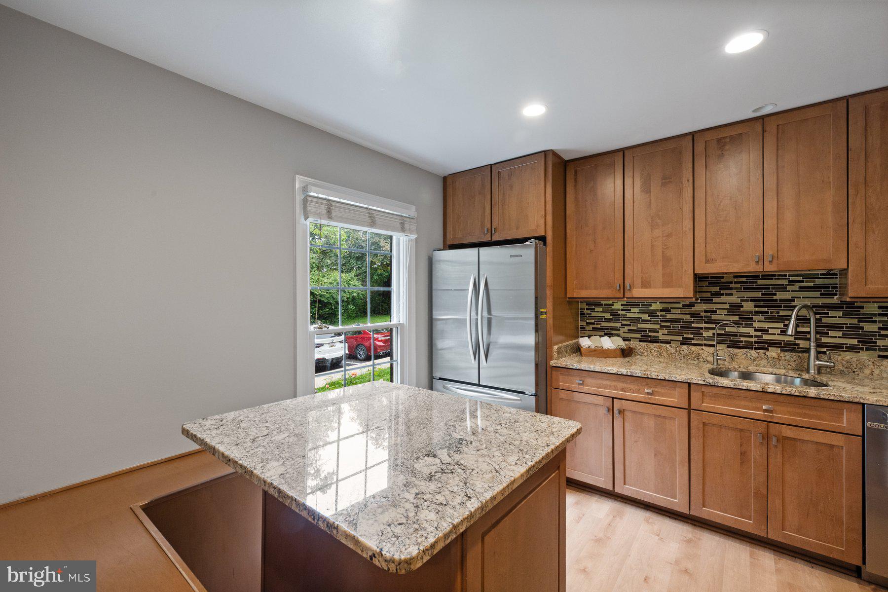 7322 Greentree Road Bethesda, MD 20817 - Photo 12 of 53 a kitchen with stainless steel appliances granite countertop a sink stove and refrigerator