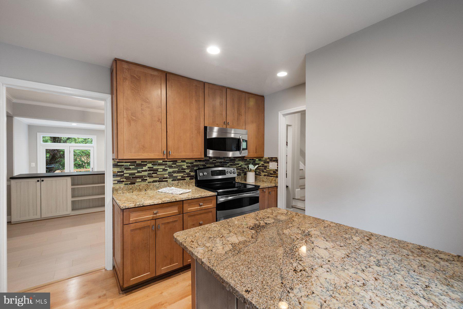 7322 Greentree Road Bethesda, MD 20817 - Photo 16 of 53 a kitchen with kitchen island granite countertop a stove and a sink