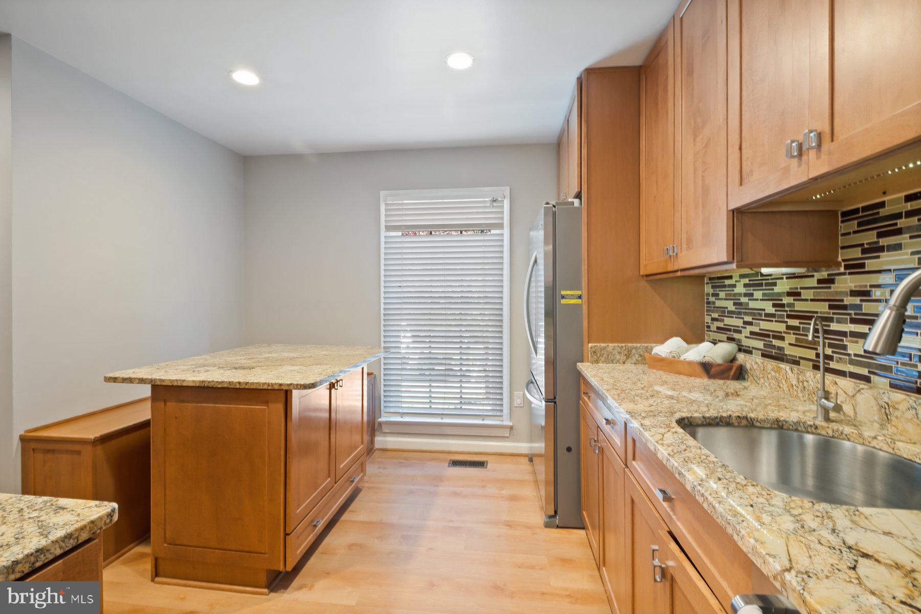 7322 Greentree Road Bethesda, MD 20817 - Photo 17 of 53 a kitchen with stainless steel appliances granite countertop a sink stove and cabinets