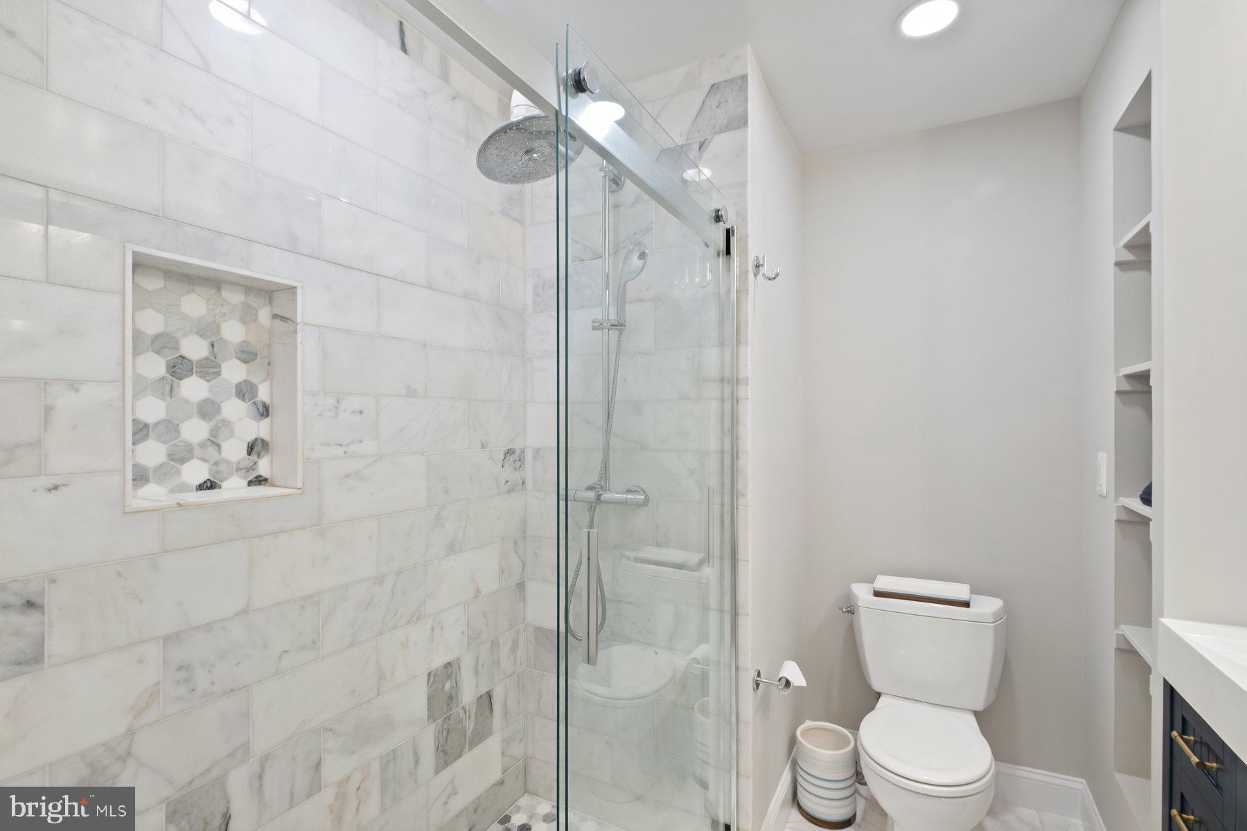 7322 Greentree Road Bethesda, MD 20817 - Photo 25 of 53 a white toilet sitting next to a bathroom sink