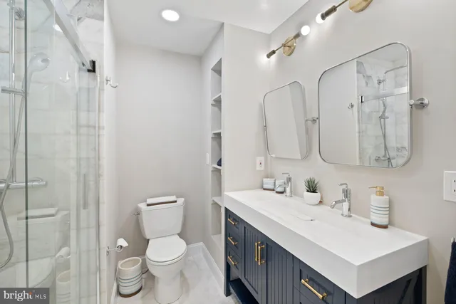 a bathroom with a toilet sink and mirror