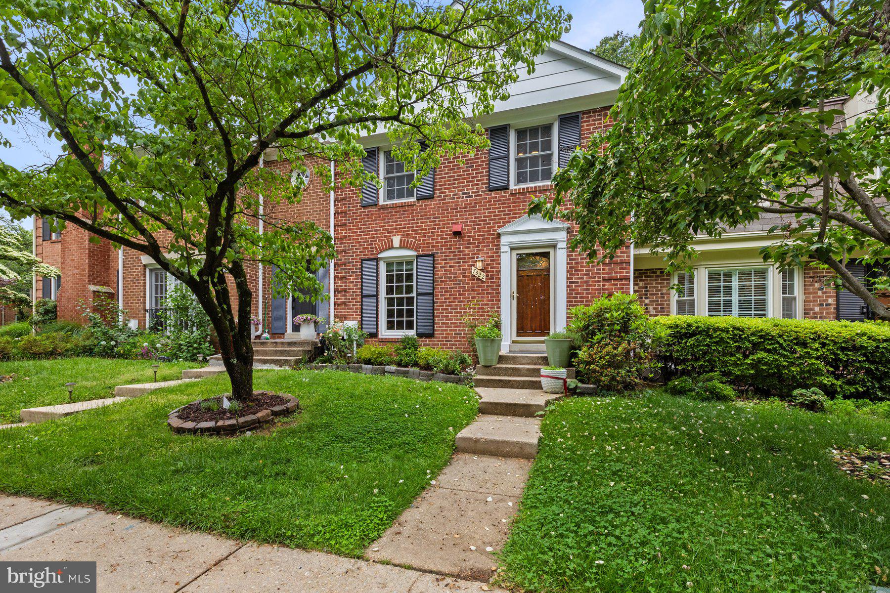 7322 Greentree Road Bethesda, MD 20817 - Photo 3 of 53 a front view of a house with a yard and large tree