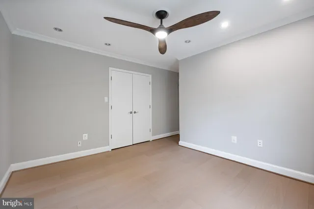 an empty room with a ceiling fan and a ceiling fan
