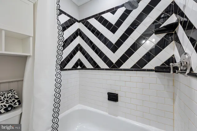 a bathroom with a bathtub and shower