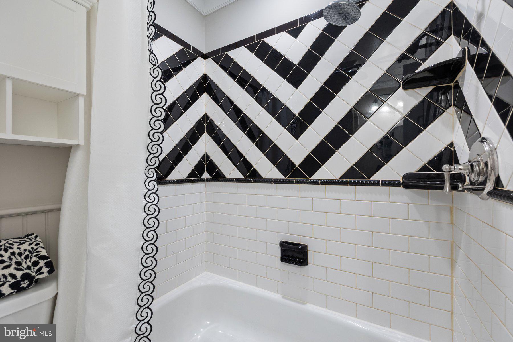 7322 Greentree Road Bethesda, MD 20817 - Photo 36 of 53 a bathroom with a bathtub and shower