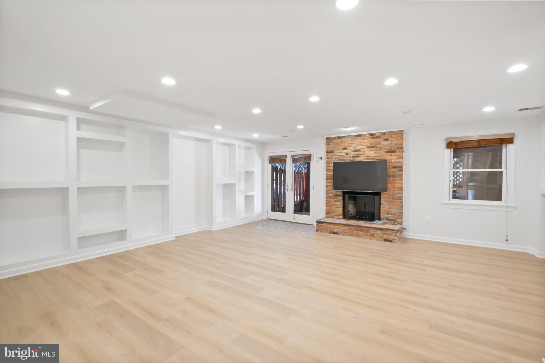 7322 Greentree Road Bethesda, MD 20817 - Photo 40 of 53 a view of an empty room with a fireplace and a window