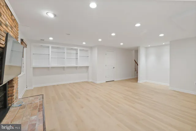 a view of an empty room with a cabinet