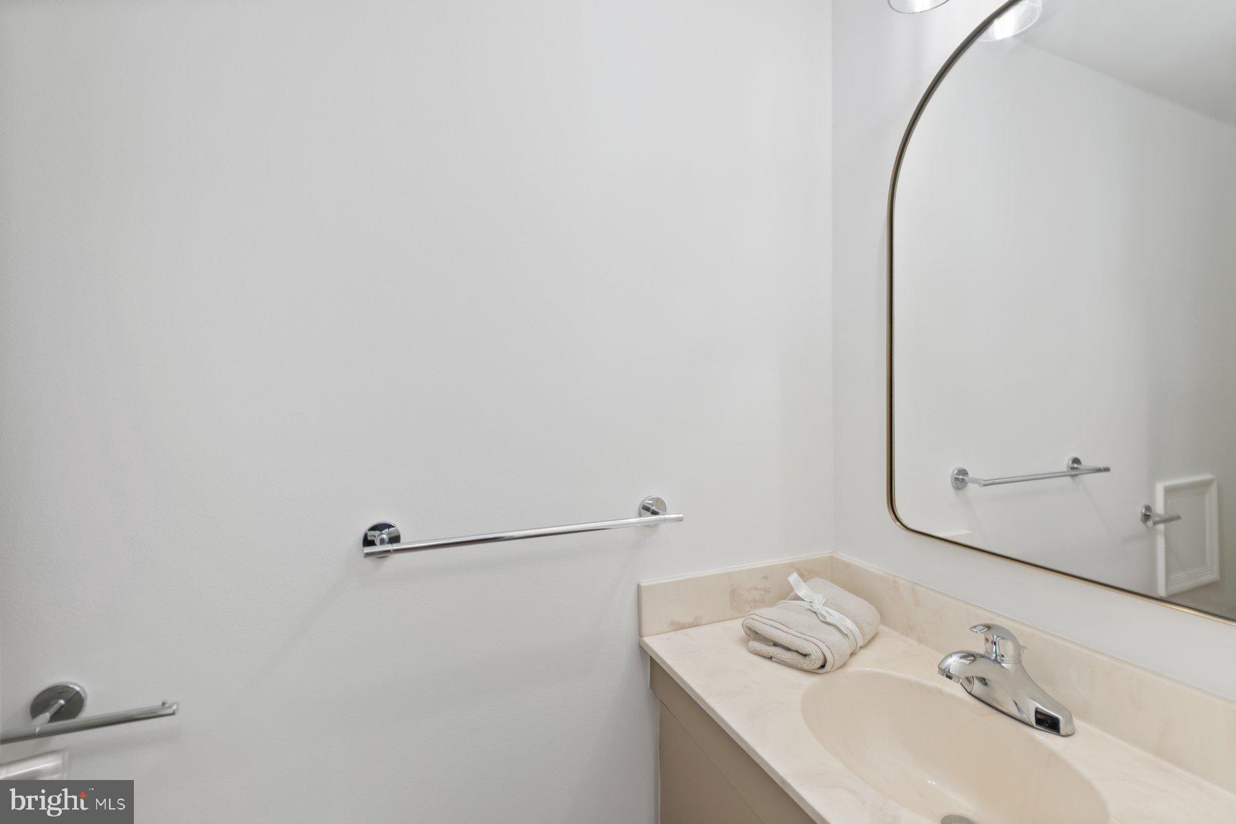 7322 Greentree Road Bethesda, MD 20817 - Photo 42 of 53 a bathroom with a sink and a mirror