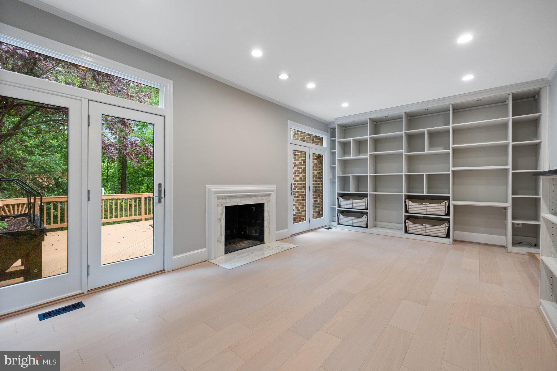 7322 Greentree Road Bethesda, MD 20817 - Photo 5 of 53 a view of an empty room with a fireplace and a window