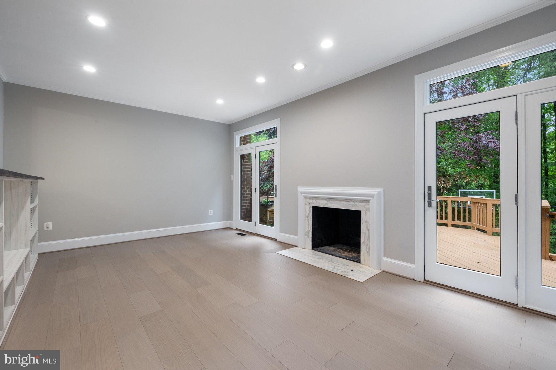 7322 Greentree Road Bethesda, MD 20817 - Photo 7 of 53 a view of an empty room with a fireplace and a window