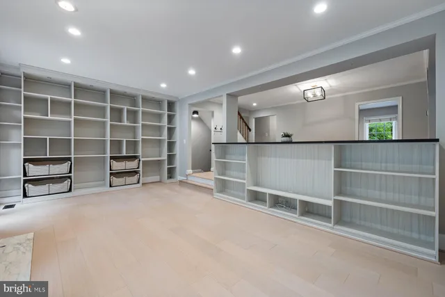 a view of an empty room with a fireplace and a cabinets