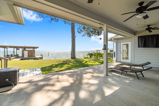 a view of a house with backyard porch and sitting area