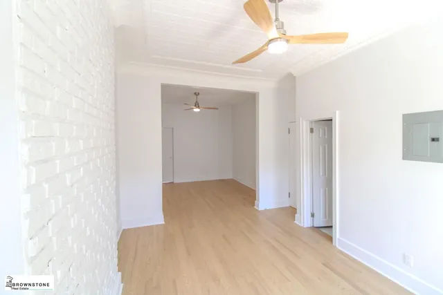 a view of hallway with wooden floor