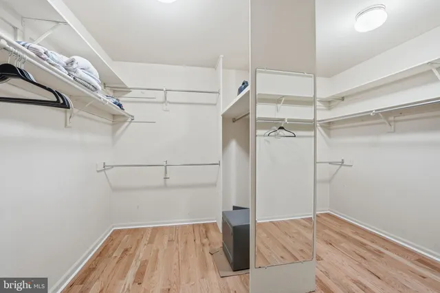 a spacious bathroom with a granite countertop sink a toilet and a bathtub