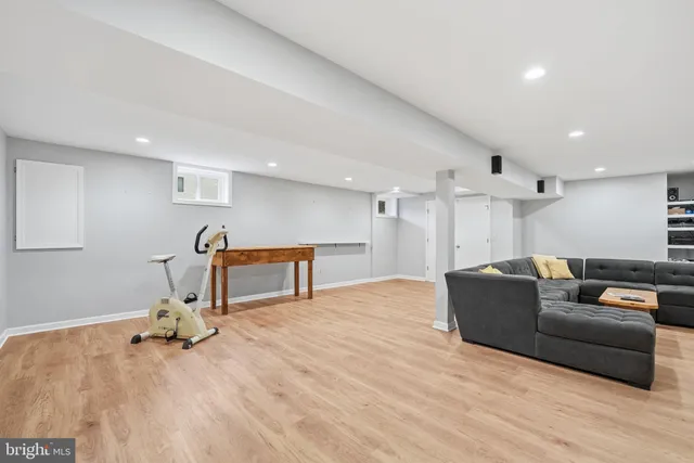 a spacious bedroom with a bed couch and a window