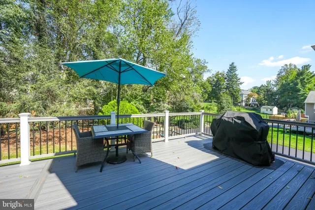 a view of a house with a patio and a yard