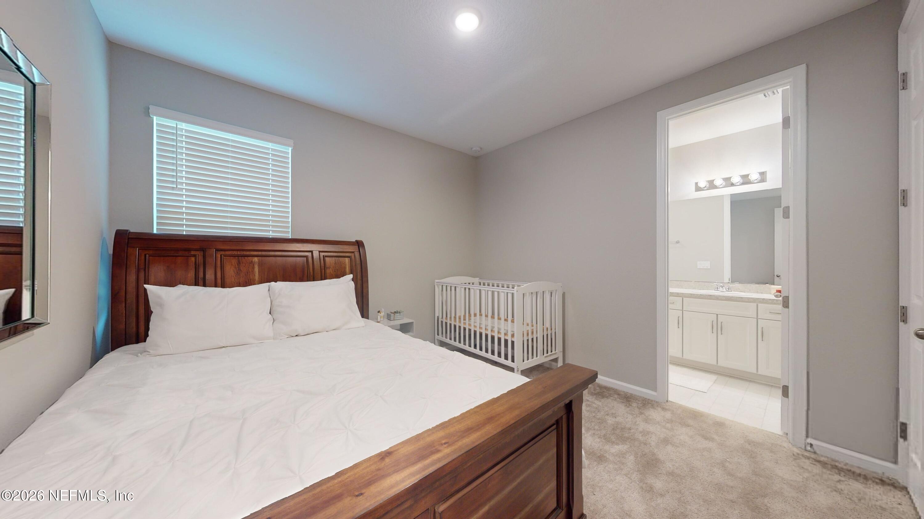 122 Field Flower Way St. Augustine, FL 32092 - Photo 11 of 55 a bedroom with a bed and a window