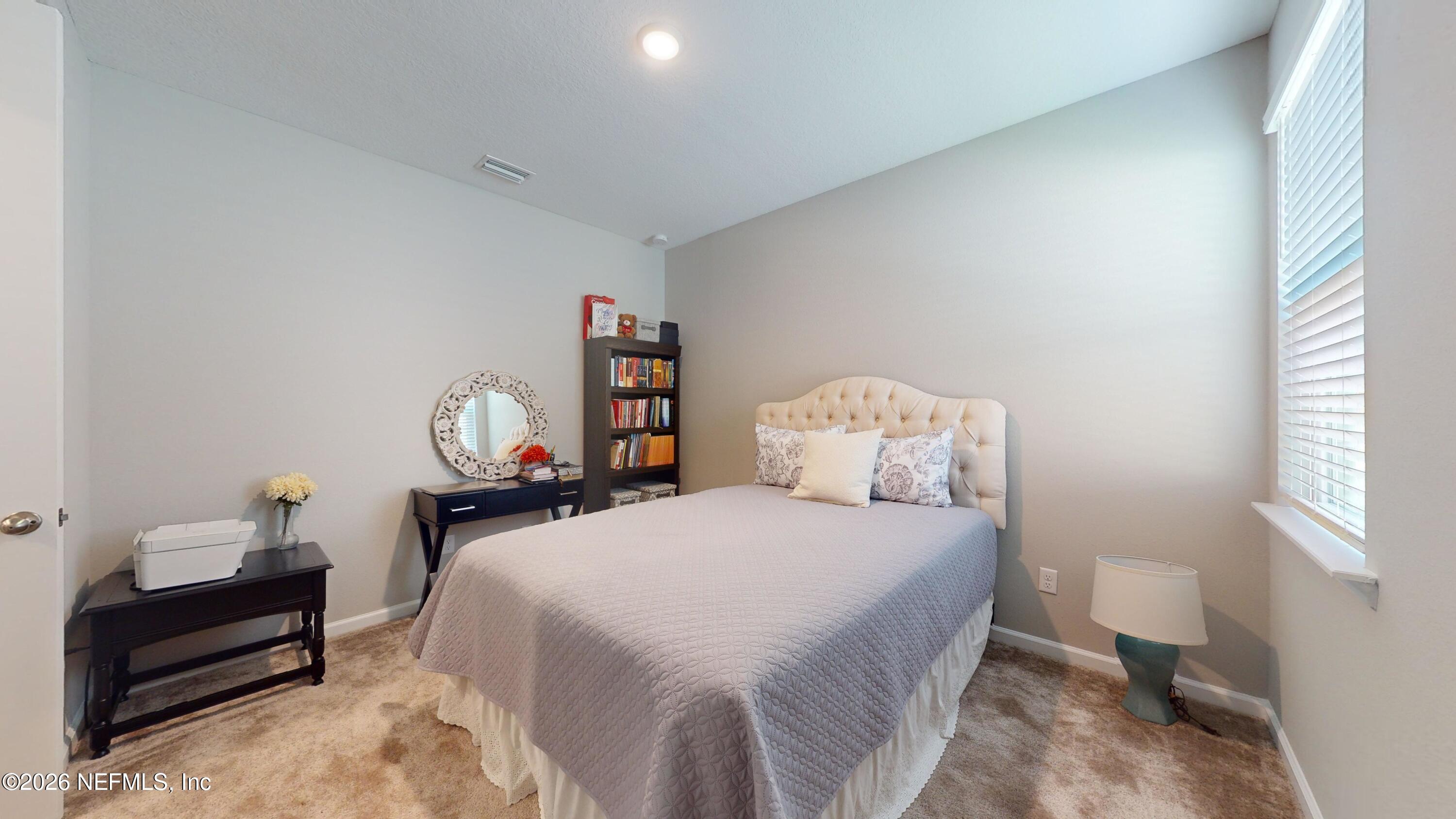 122 Field Flower Way St. Augustine, FL 32092 - Photo 15 of 55 a bedroom with a bed and a table