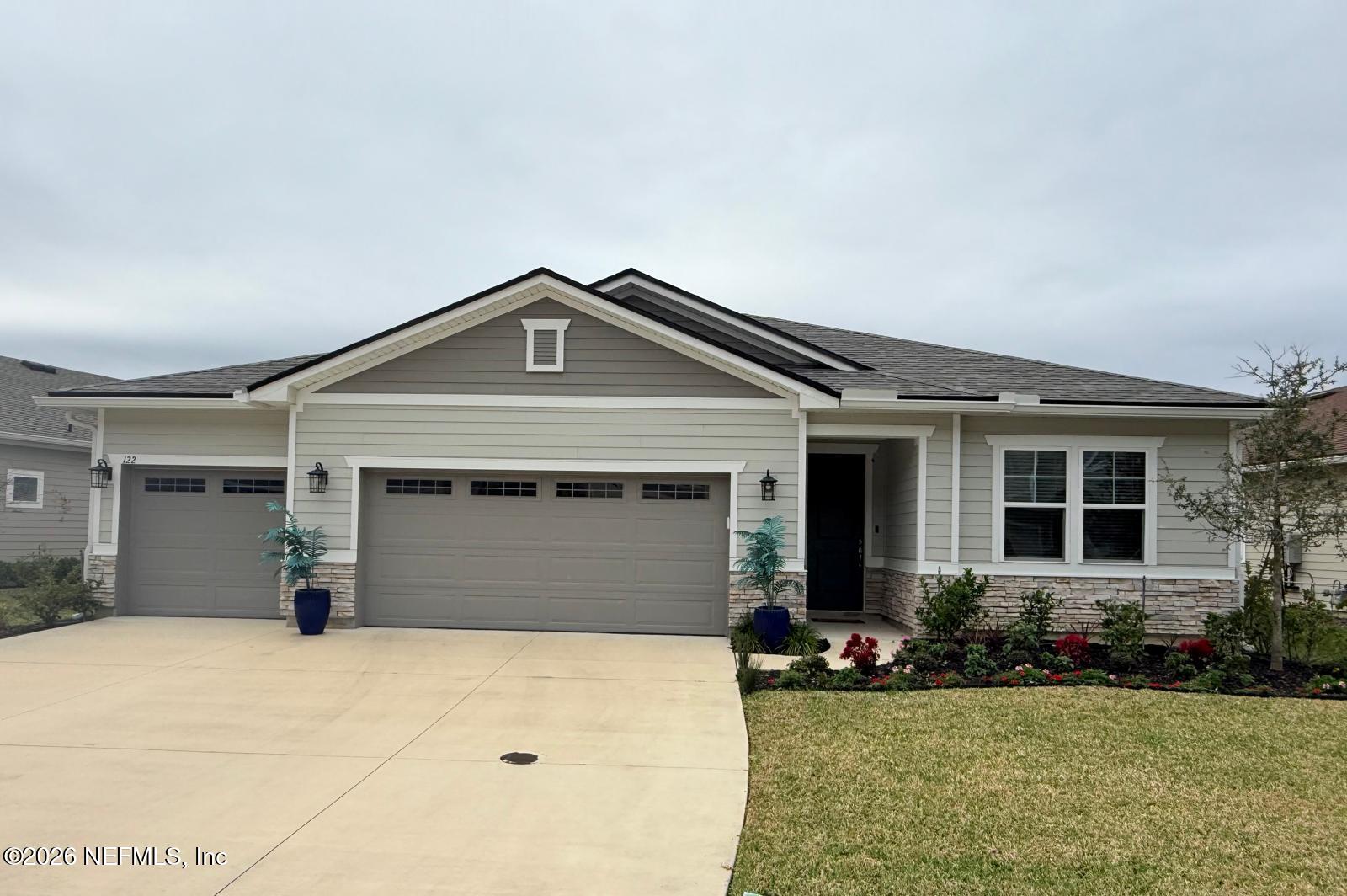 122 Field Flower Way St. Augustine, FL 32092 - Photo 2 of 55 a front view of a house with a yard and garage
