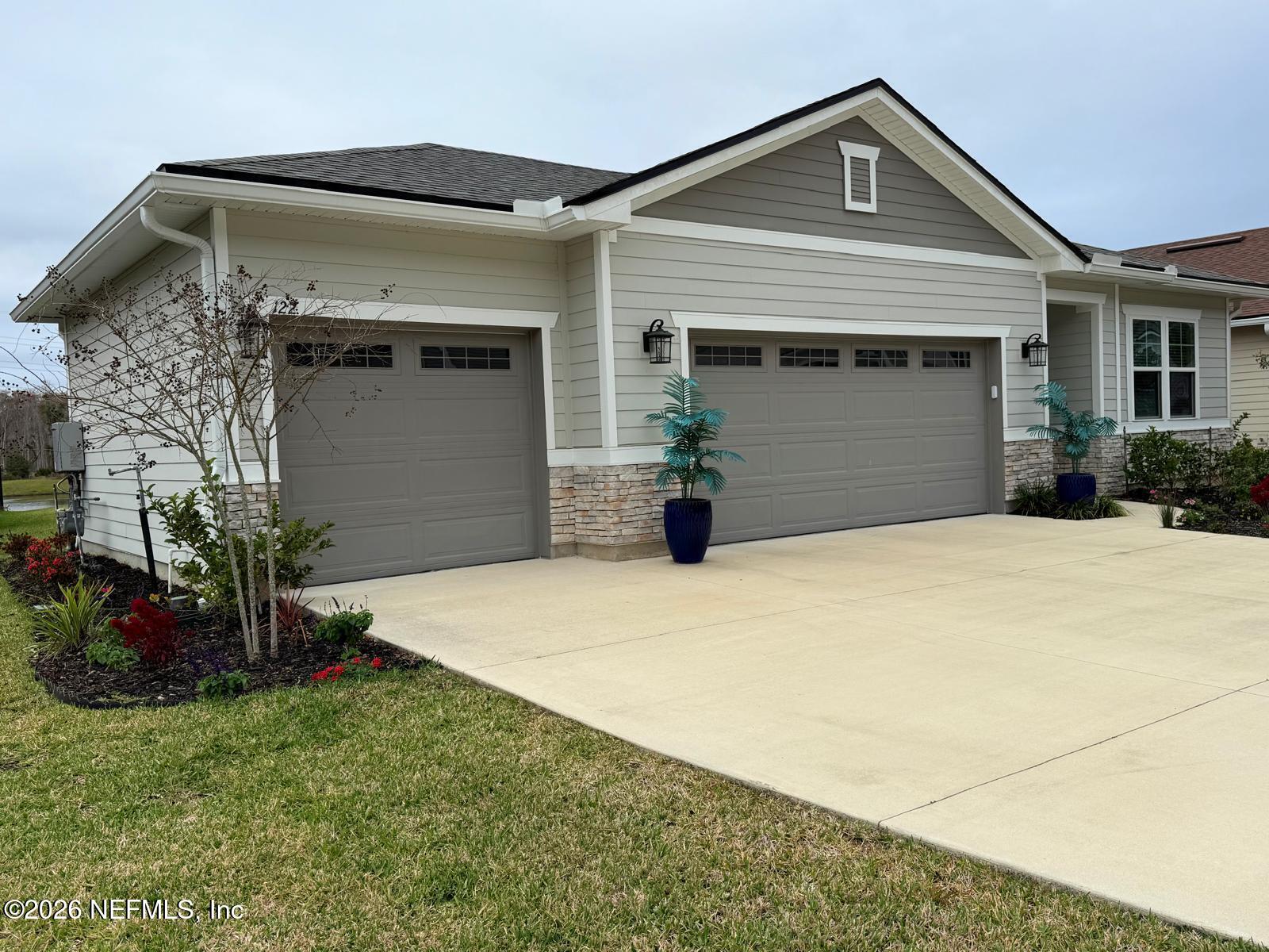 122 Field Flower Way St. Augustine, FL 32092 - Photo 4 of 55 a front view of a house with a yard and garage