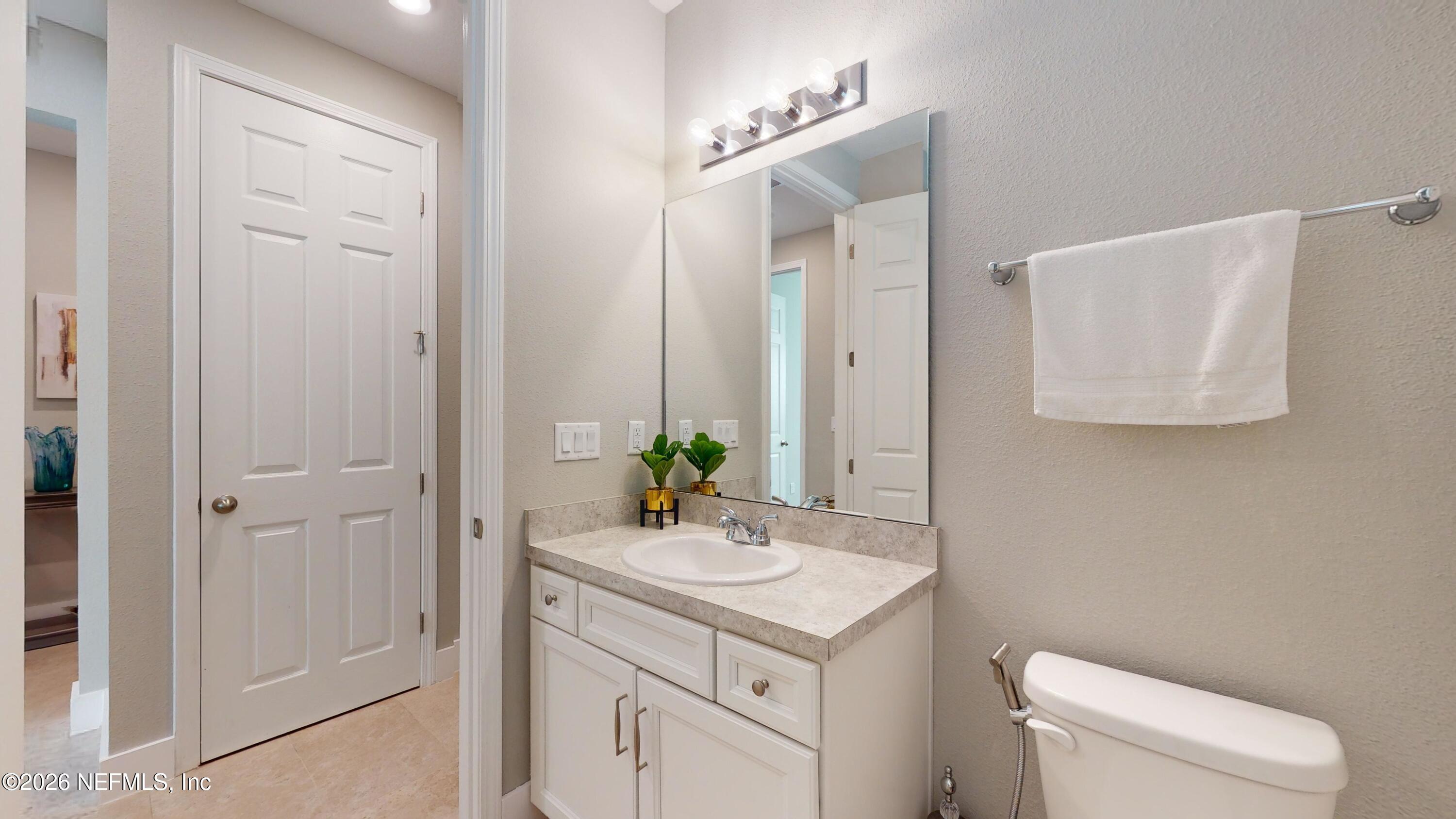 122 Field Flower Way St. Augustine, FL 32092 - Photo 9 of 55 a bathroom with a toilet sink and mirror