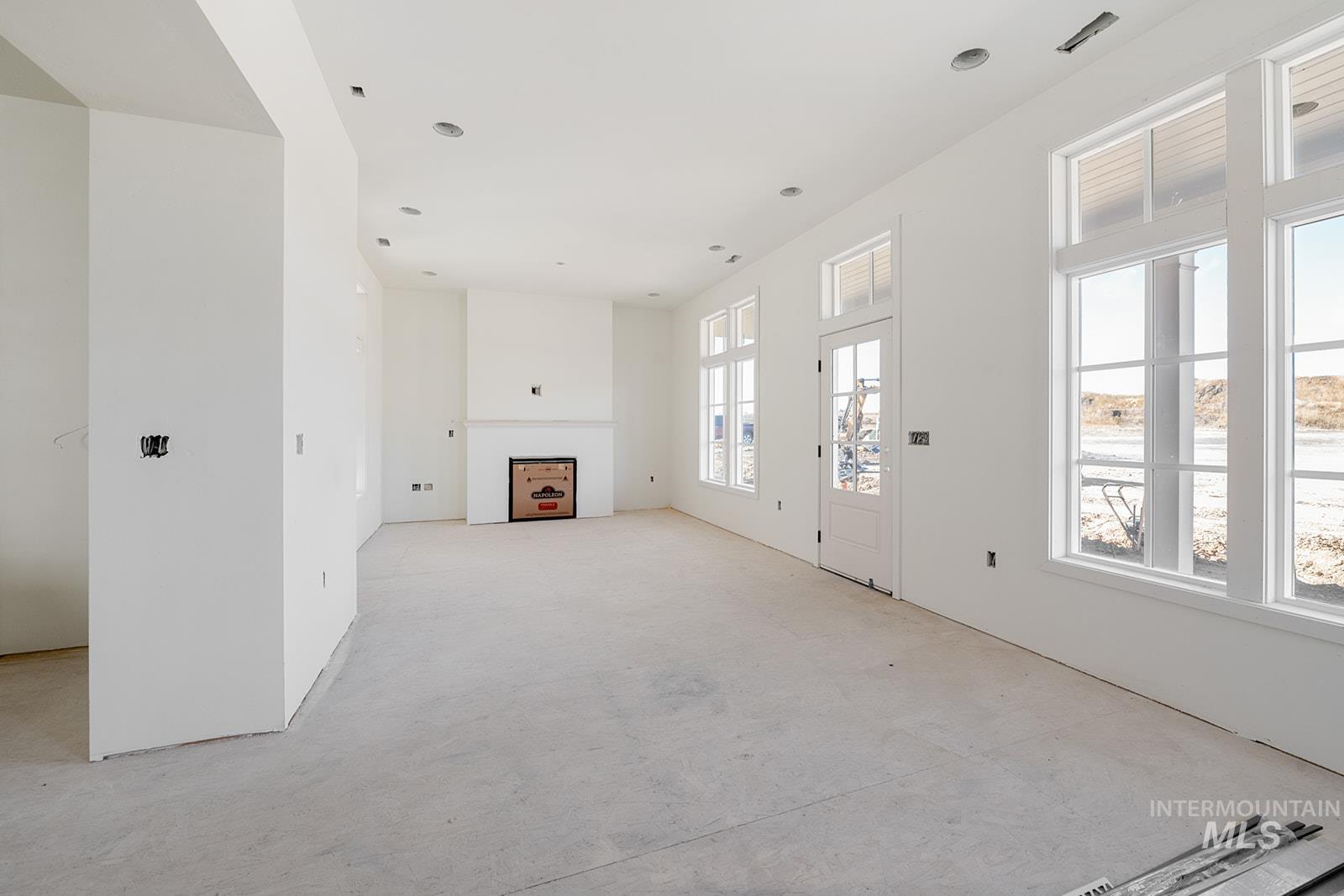 1452 Picotee Circle, Unit ROSE Moscow, ID 83843 - Photo 6 of 19 Unfurnished living room featuring a fireplace and light colored carpet