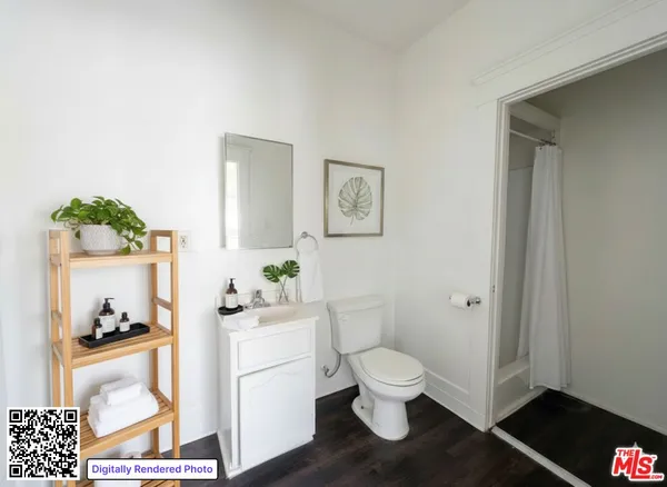 a white toilet sitting next to a bathroom sink