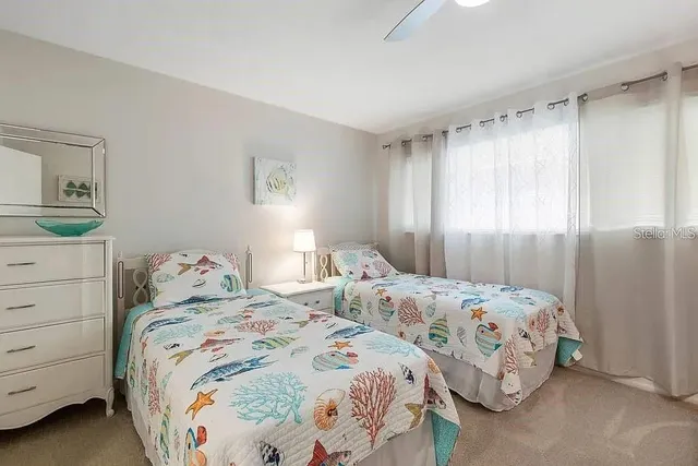 a bedroom with two beds and a dresser