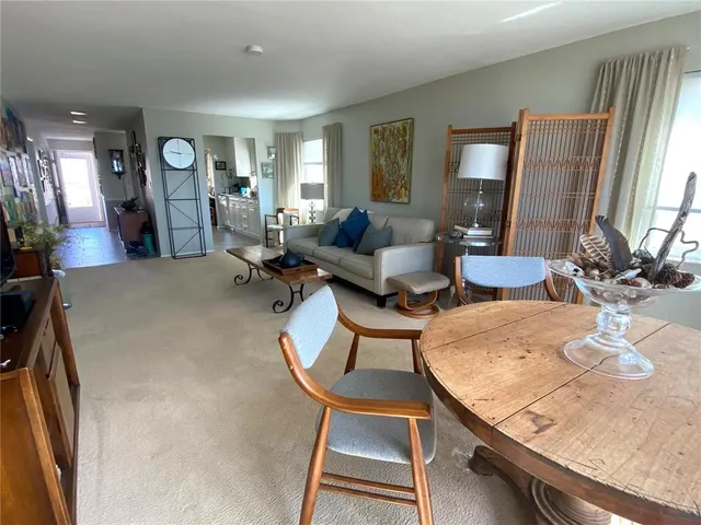 a living room with dining table and chairs