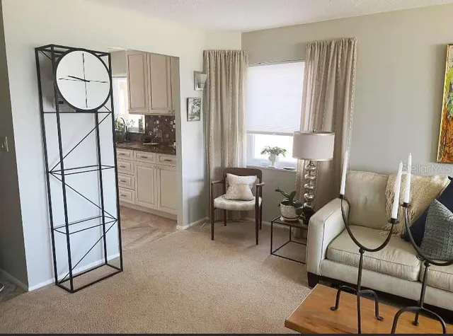 a living room with furniture a window and wooden floor