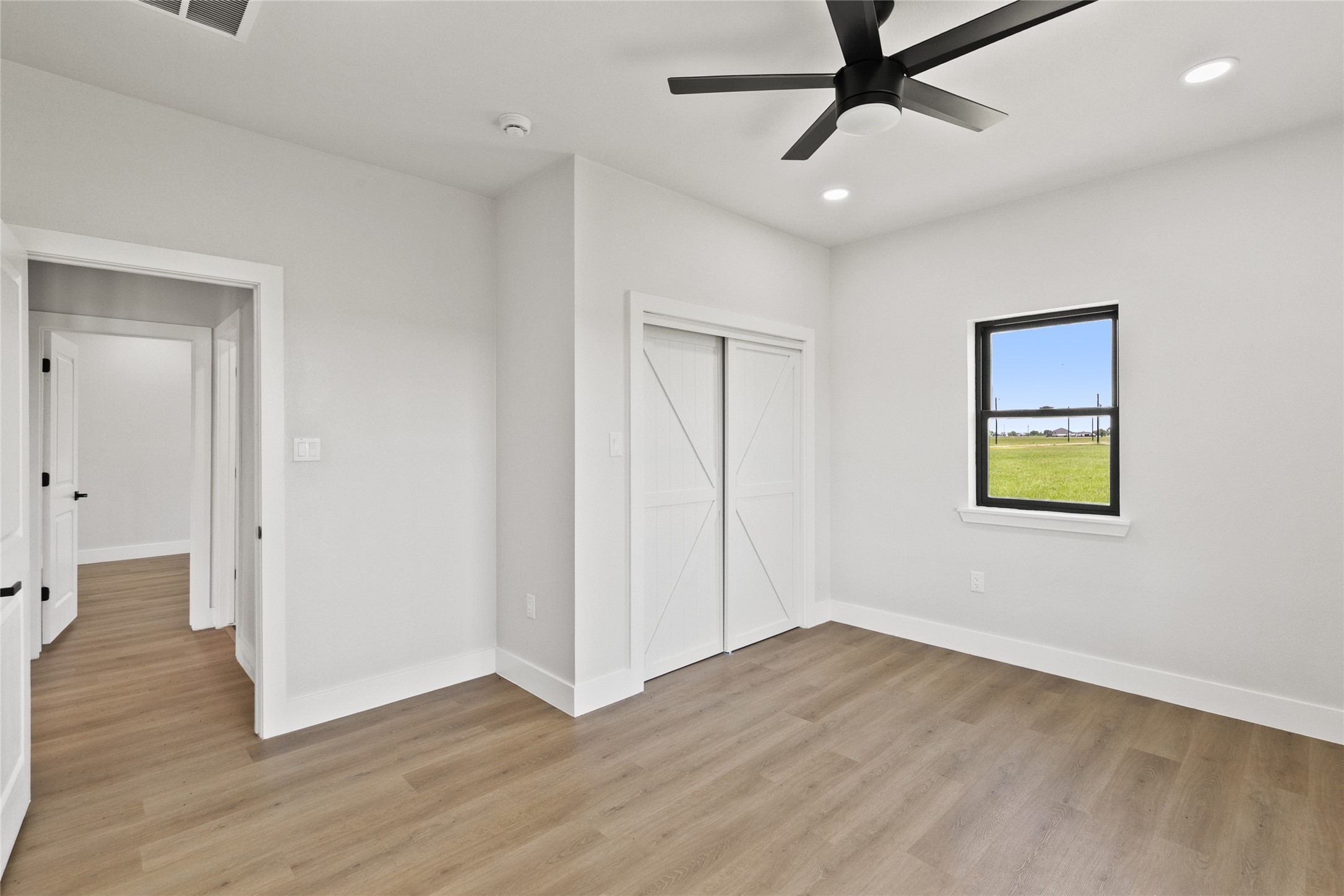 619 Chuckwagon Trail Angleton, TX 77515 - Photo 30 of 37 Additional secondary bedroom located near the full guest bathroom, offering flexibility for guests, hobbies, or everyday living. Includes a closet and ample natural light.