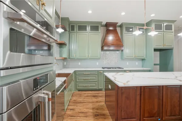 a kitchen that has a sink and a stove
