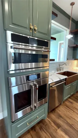 a stove top oven sitting inside of a kitchen